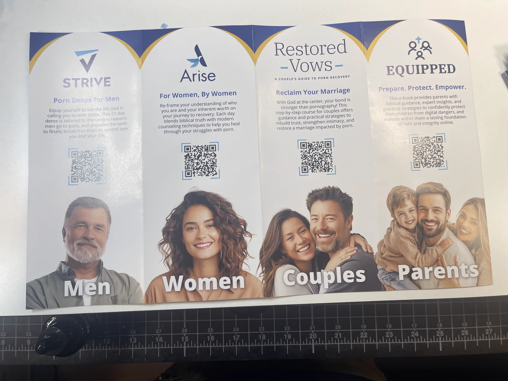 The production gatefold brochure photographed open on a desk, the Strive, Arise, Restored Vows and Equipped panels headed Men, Women, Couples and Parents.
